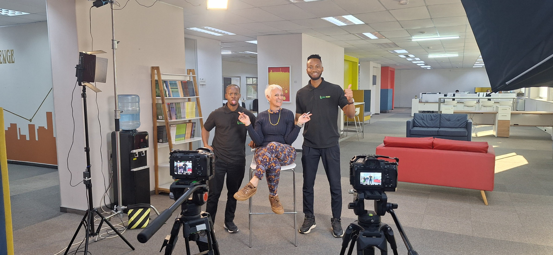 Behind-the-scenes field production — a stakeholder interview being filmed on location.